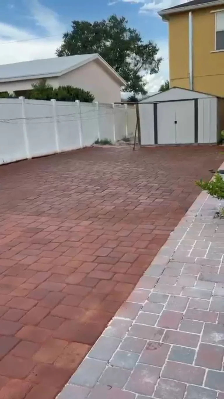 Red brick paver driveway design enhancing residential curb appeal in Orlando, Florida — Rock Pavers.