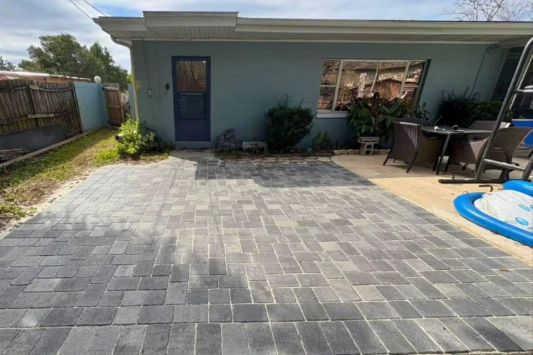 Backyard stone paver patio installation with gray and charcoal tones in Orlando, Florida — Rock Pavers.