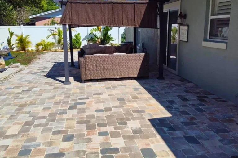 Outdoor living space with natural stone pavers beneath a shaded pergola in Orlando, Florida — Rock Pavers.