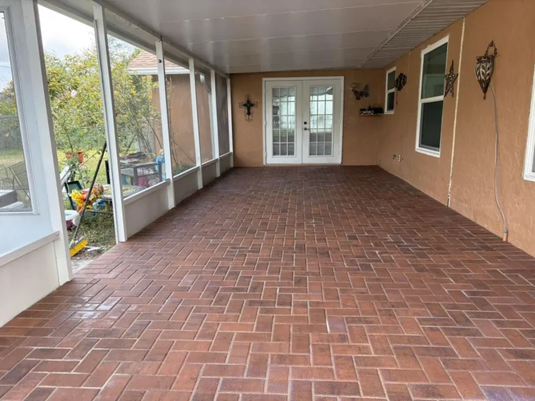 Enclosed screen porch patio featuring textured earth-tone pavers in Orlando, Florida — Rock Pavers.